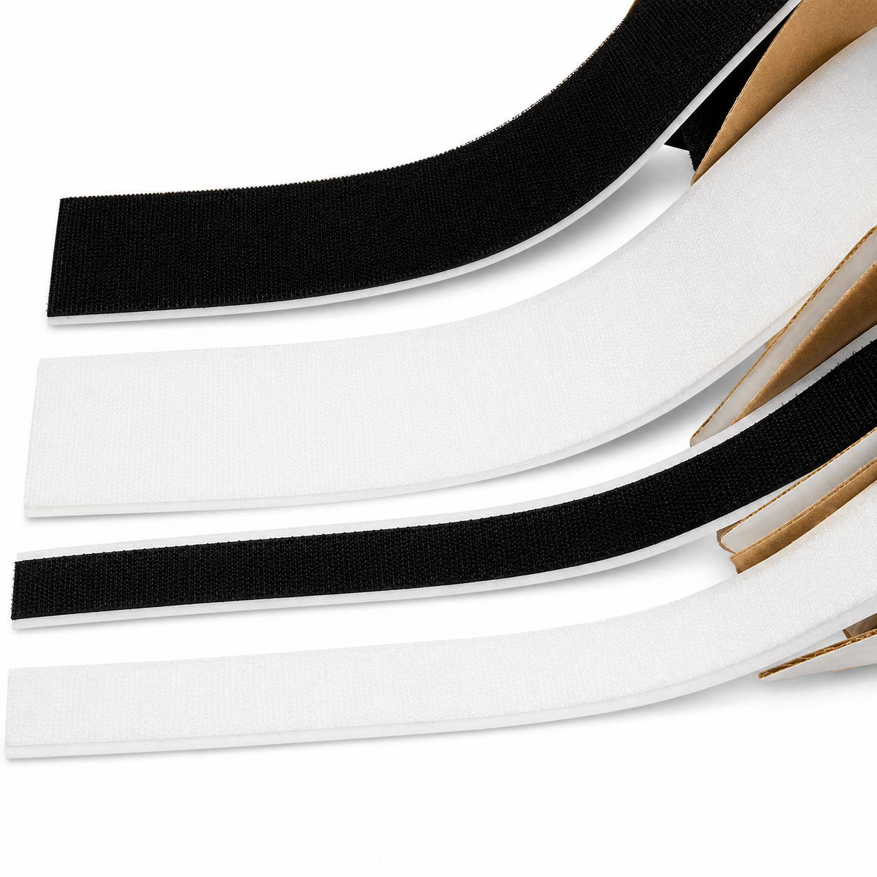 Three adhesive hook-and-loop fastener strips shown on a white background, with black loops and white backing tapes layered diagonally. A small cardboard core is visible along the right side of the strips.
